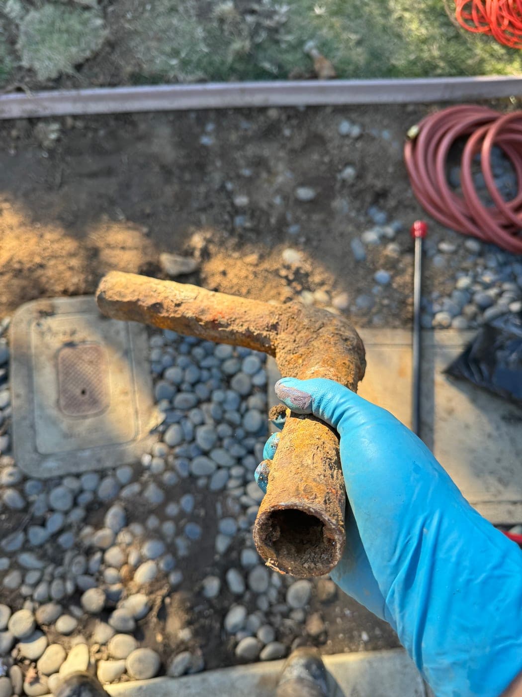 Corroded galvanized water pipe with the bore nearly closed by rust