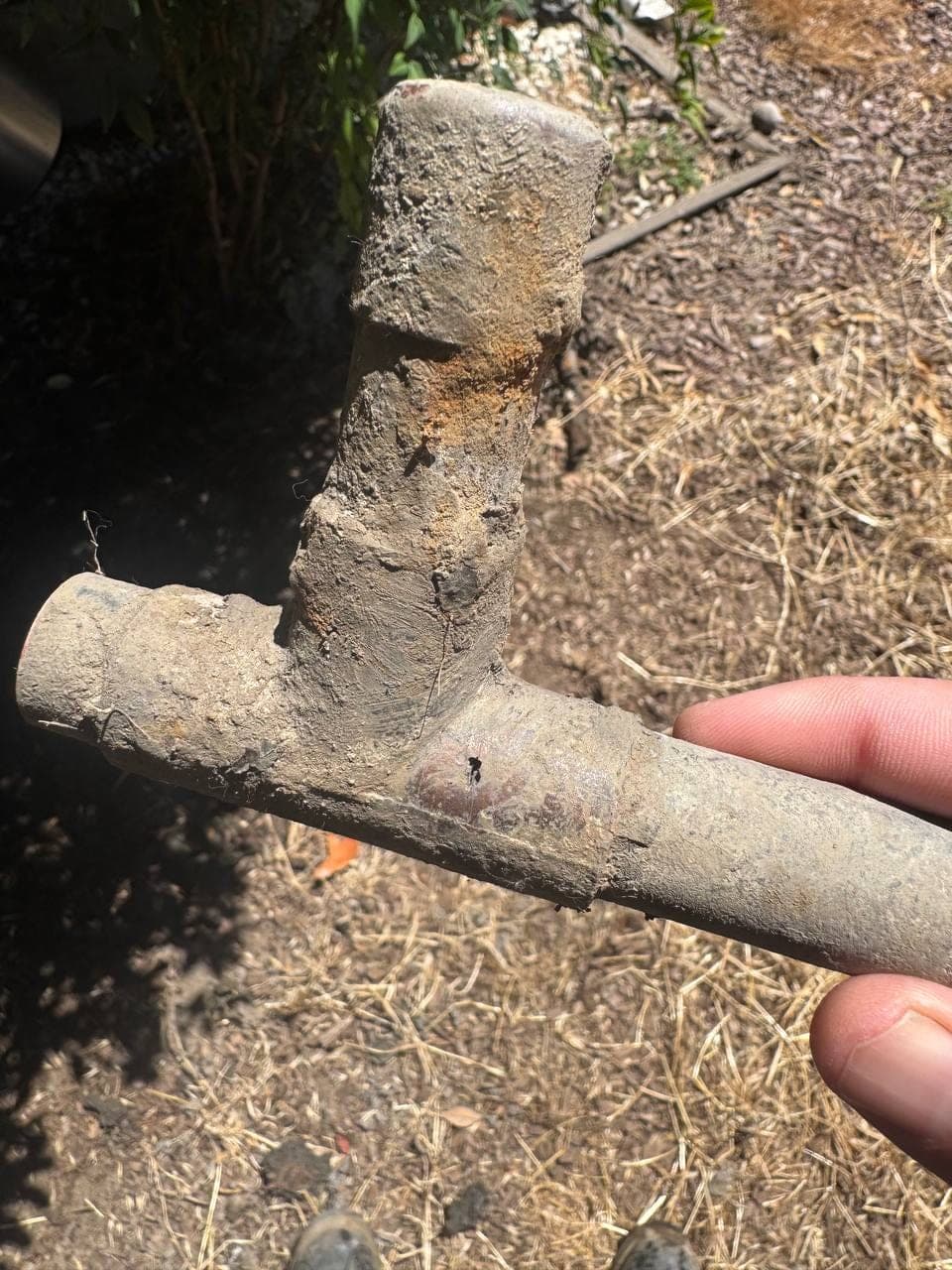 Corroded tee fitting cut from a leaking copper water main